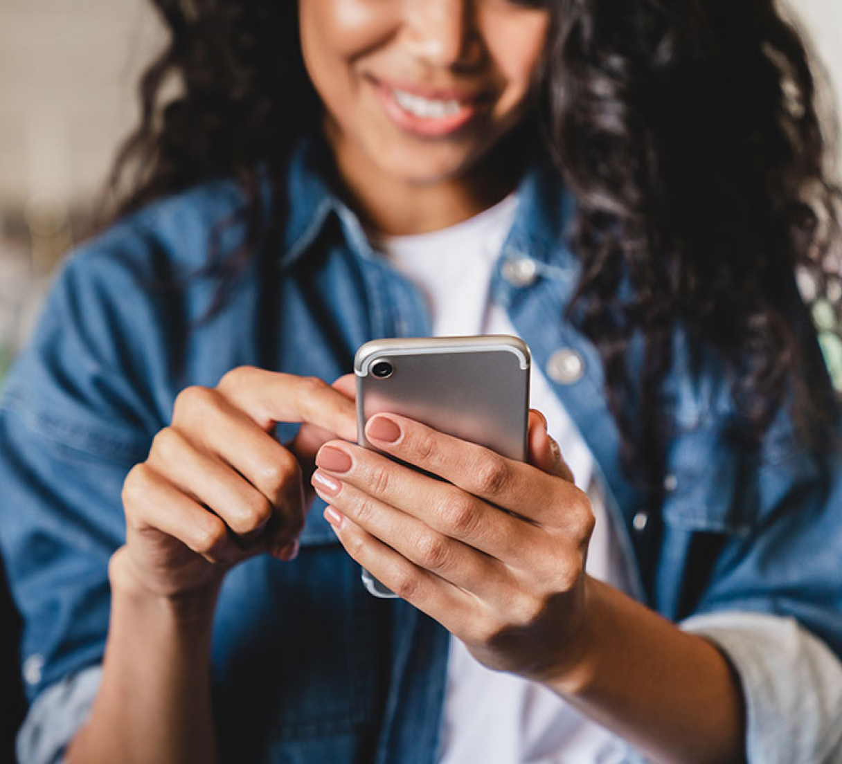 Young woman browsing MyUSAFinance.com on her mobile phone