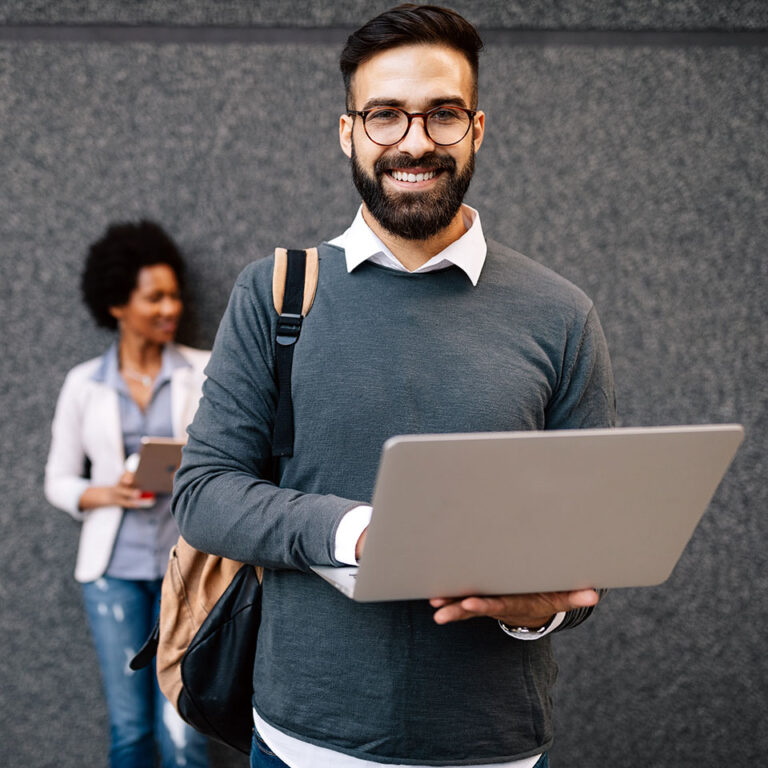 Happy young man using his laptop to get a personal loan from MyUSAFinance