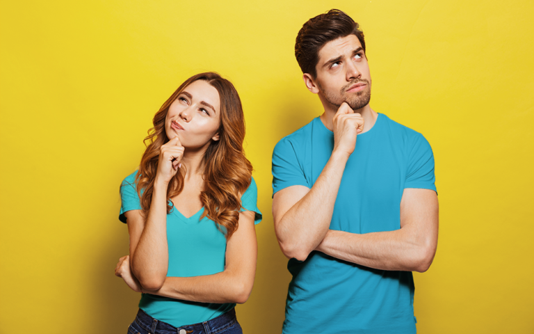 A man and a woman considering the terms of their loan offer.