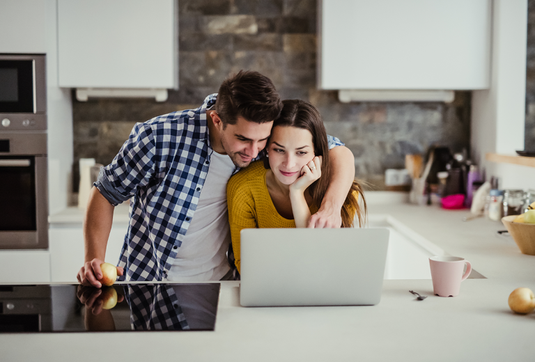 couple looking up personal loan requirements computer