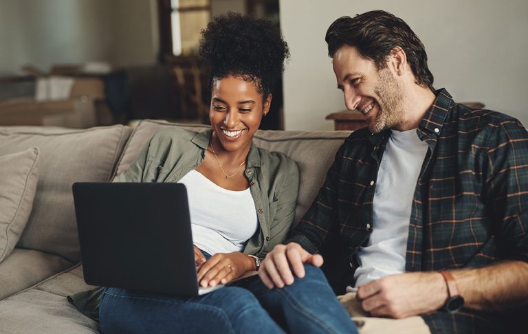 Couple looking at credit report on laptop