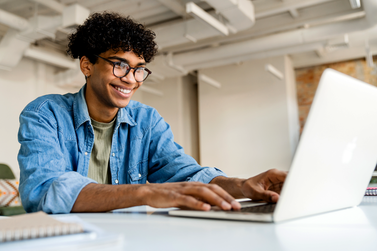 man using laptop at the desk