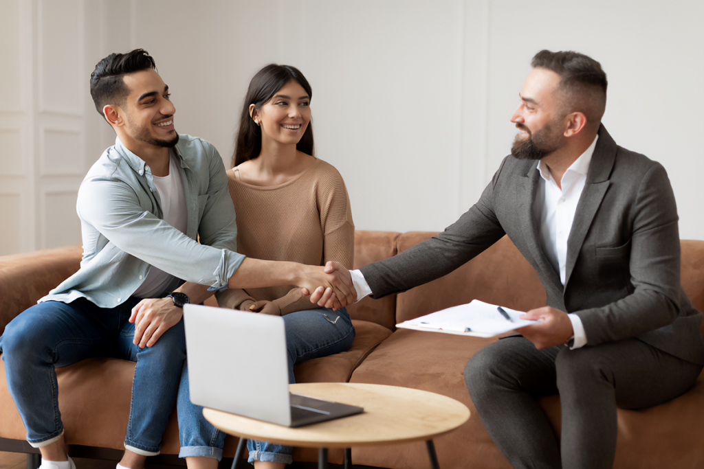 Couple Buying New home, Shaking Hands With loan agent