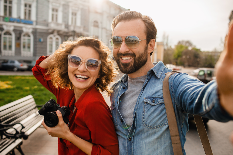 Man and woman on vacation wearing sunglasses