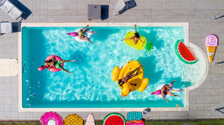 friends having fun backyard pool