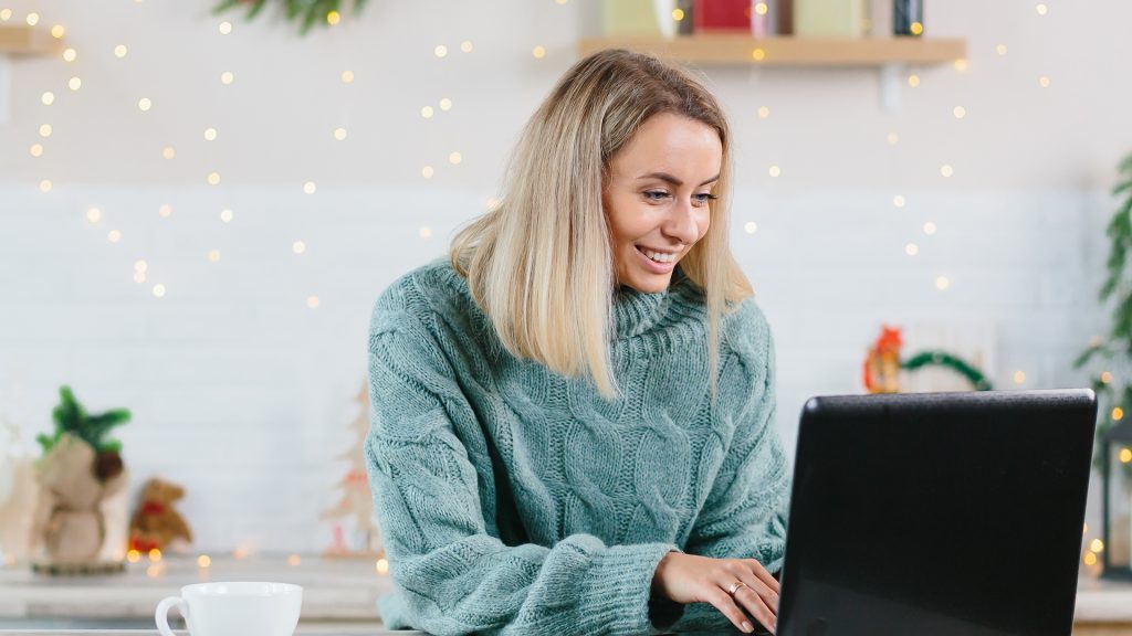 woman working at home on laptop during Christmas and New Year